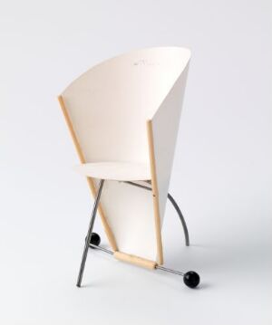  A modern minimalist chair with a curved plywood seat in a light cream color and a dark metal frame, set against a plain white background.