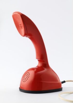  A glossy red Ericofon designed by Hugo Blomberg, showcasing a sleek one-piece design with an integrated rotary dial and a cream-colored cord on a white background.