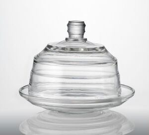  Pressed glass butter dish with ridged dome cover, designed by Sverre Pettersen, displayed against a light gradient background, embodying a minimalist and functional design.