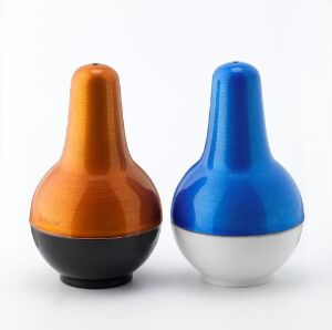  Two stylized pear-shaped objects side by side; the taller one has an orange to black gradient, and the shorter one is half blue, half white, both with a glossy finish on a white background.