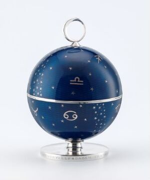  A spherical bonbonnière designed by Hanna Visund with a deep blue enamelled upper half featuring silvery celestial patterns, a mirrored silver equatorial band, and a polished silver base, crafted using sterling silver and enamel.