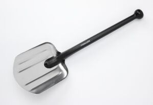  A silver metal shovel with a long black handle laying diagonally on a white background, with subtle shadows indicating that it's lying on a flat surface.