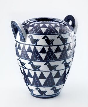  A two-handled ceramic vase with horizontal bands of navy blue patterns on a white background, featuring chevrons and stylized bird motifs.