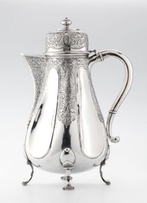  "Sjokoladekanne," an elegant silver chocolate pot crafted by Michel Michelsen Rømer, with a bulbous body, ornate feet, an intricate handle, and a decorated lid crowned with a finial, exhibiting