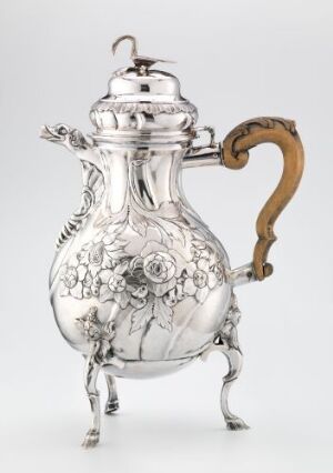  "Kaffekanne" by Bernt Christopher Kelberlade - an exquisite silver coffee pot with a wooden handle, featuring embossed floral patterns and standing on three ornate silver feet, reflecting the intricate design and craftsmanship of traditional silverwork artistry.