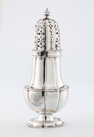  A polished silver sugar caster with intricate openwork patterns and an embossed crest, set against a light grey background.