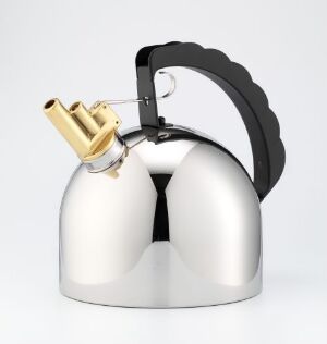  Richard Sapper's "9071" kettle design in stainless steel, featuring a curved black plastic handle, a vertical front seam, and a brass whistle where a spout would typically be, against a muted grey background.