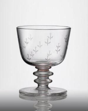  A clear, blown glass goblet with engraved branch and leaf designs on the bowl, and a twisted stem design, crafted by Ståle Kyllingstad.