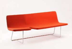  "Break" by Norway Says, a modern bench with vibrant red fabric-covered bentwood for the seat and backrest, complemented by a sleek silver metal frame, against a white background.