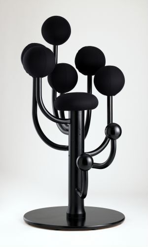  A modern black beech wood and wool coat stand by Stokke with spherical hooks at varying heights attached to curved arms, all mounted on a circular base.