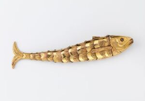  A segmented golden fish figure on a light-gray background, showcasing articulated scales and a lifelike form.