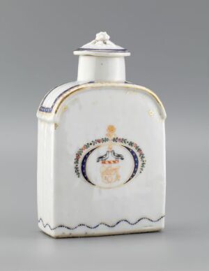  A small white porcelain bottle or jar with a round lid, featuring a circular crest or coat of arms in the center, flanked by gold and navy blue decorative elements.