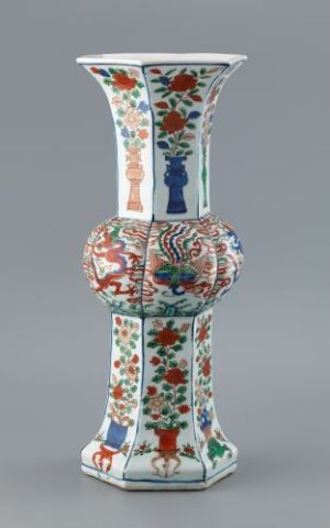  Ornate vase with a wide mouth and bulbous center, decorated with detailed multicolored floral patterns on a white background.