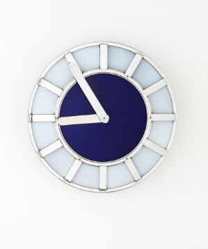  A modern clock designed by Jacob Tostrup Prytz titled 'Juveler J. Tostrup' with a nickel-plated steel frame and segments of sky blue and cobalt blue colored glass, with sleek steel hands accentuating the minimalist design.