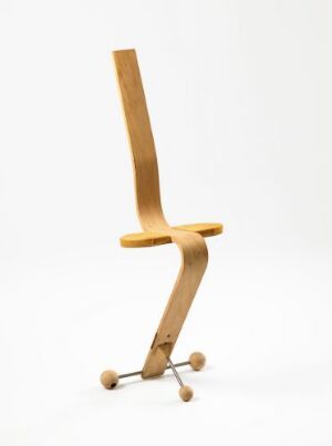  "Mini version 2" – a modern chair designed by Terje Ekstrøm with a curved, vertical backrest and seat made of warm-toned wood veneer, featuring a formbent laminated wooden structure and a tripod-like base with spherical wood-ball feet, against a white background.