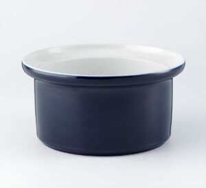  "Korulenserviset" by Porsgrunds Porselænsfabrik AS - a navy blue glazed porcelain bowl with a flat rim and glossy white interior, set against a light background.