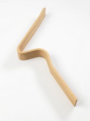  "Ekstrem Maestro," an industrial design object by Terje Ekstrøm, depicting a smoothly curved S-shaped form made from warm-light-brown bent plywood against a white background.