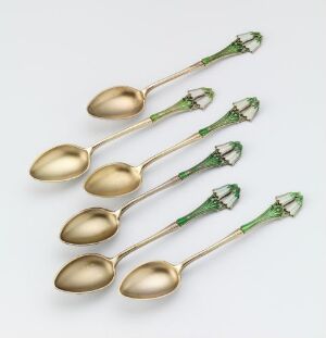  A set of six gilded silver spoons with detailed green guilloche enamel on the handles, crafted by Gustav Gaudernack, displayed against a light gray background.