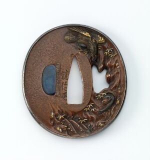  A round, carved bronze tsuba (Japanese sword handguard) with a large central opening and a crescent-shaped aperture, featuring gold-accented plant reliefs against a rich brown backdrop.