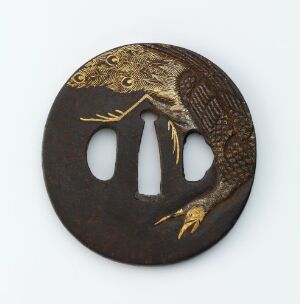  An antique Japanese tsuba (sword guard) featuring a mid-flight eagle with golden inlays against a dark, brownish metal background, exhibiting traditional design with one main and two auxiliary openings.