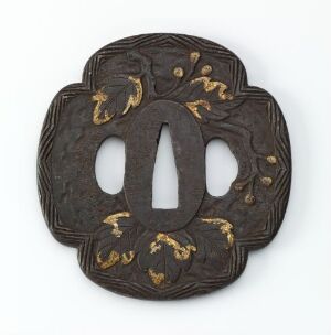  A round, dark metal Japanese sword hand guard, or tsuba, with scalloped edges, a large central opening, two smaller side openings, and gold inlay decoration of plant-like patterns. Artist name and title are unknown.