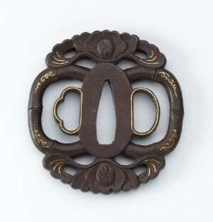  An ornate, circular dark brown decorative hardware piece with gold-trimmed, interlocking oval shapes at the center, surrounded by symmetrical leaf-like motifs, set against a light neutral background.