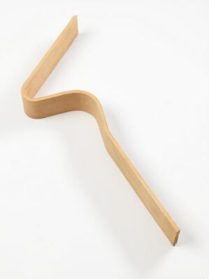  "Ekstrem Maestro," a unique piece of light-brown plywood furniture, features an elegant, continuous, formbent design that serves as both a backrest and seat, against a white background, by designer Terje Ekstrøm.