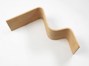  "Ekstrem Maestro," a curvaceous furniture piece designed by Terje Ekstrøm, crafted from light-toned plywood with a natural finish, set against a pure white background.