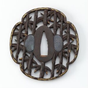  An intricately designed, circular bronze or dark brown metal object with a lattice pattern and an oval opening in the center, placed against a neutral light gray background.