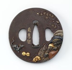  A circular Japanese tsuba (sword guard) with intricate metalwork depicting a warrior and mythical creatures. The guard has a brown patina with gold, copper, and silver-colored inlays, including Kanji characters, on a dark metal surface.