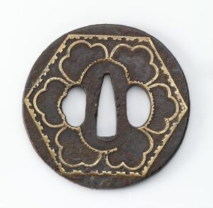  An antique circular metal coin with a central oval hole and decorative clover-like embossing, featuring contrasting dark brown and worn golden colors on a neutral grey background. Artist name and title are unknown.