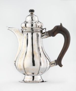  A silver fluted coffee or teapot with a domed lid and wooden handle, set against a neutral background, demonstrating classic design and reflective surface.