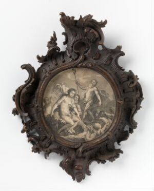  An antique oval frame with Baroque-style scrollwork in dark brown, possibly designed to represent carved wood or bronze, encases a lighter-colored classical depiction of two playful or battling figures, reminiscent of mythological scenes or putti.