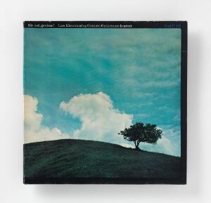  A color offset print on paper titled "Riv ned gjerdene! Lars Klevstad og Guttorm Guttormsen kvartett" by artist Bruno Oldani, depicting a minimalistic landscape with a dark silhouette of a lone tree perched on a rolling hill, against a sky gradient from light turquoise to deep blue with scattered white and gray clouds.