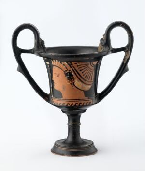  An ancient Greek or Roman kylix with black-figure pottery decoration and curved handles, featuring traditional scenes on a red-orange clay background against a neutral gray backdrop. Artist name and title are unknown.