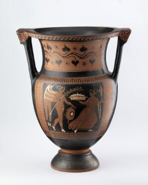  An ancient Greek black-figure krater, with a central depiction of a male figure holding a shield, framed by palmette and lotus patterns above, and wavy lines below, all in terracotta red with black detailing.