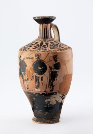  Ancient Greek amphora from the Phanyllis-gruppe, made from clay with black-figure painting. The vase has a flared rim, two vertical handles, and shows faded black silhouetted figures on a reddish background.