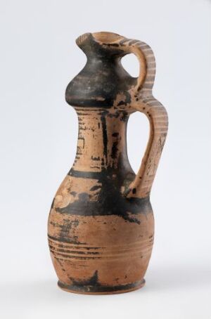  An ancient terracotta pitcher with a bulbous body, slender neck, and a single handle, decorated with horizontal black and brown patterns against a light background, suggesting historical Mediterranean or Near Eastern origins.