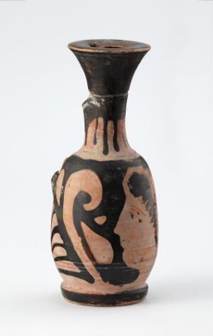  An ancient terracotta vase with black designs, featuring stylized figures and swirling patterns, set against a pale grey background.