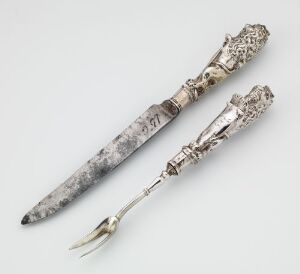  An antique knife and fork set titled "Kniv og gaffel" by an unidentified artist, crafted from engraved silver with a steel blade on the knife, set against a light grey background, reflecting a historical and luxurious quality.