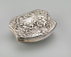  A small, intricately detailed silver box with a relief design featuring figures and swirling patterns, shown in a semi-open position.