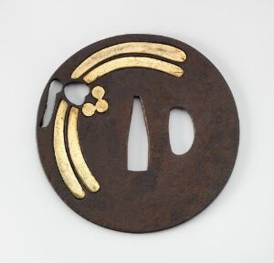  A circular dark brown metallic disc with artistic golden inlaid patterns and two vertical cut-outs, suggestive of decorative or symbolic artistry, displayed against a light grey background. Artist name and title are unknown.