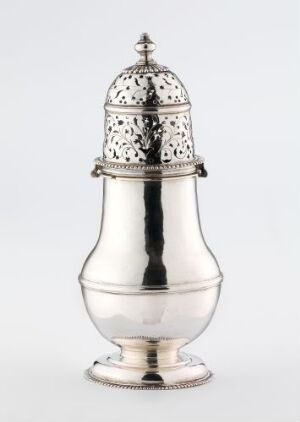  An elegant, possibly silver sugar shaker with a highly reflective surface and an ornate pierced lid on a flat base, set against a neutral grey background.