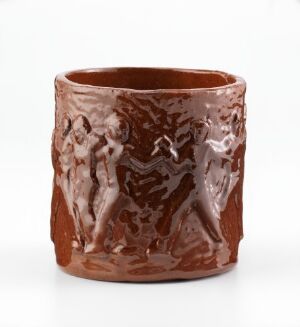  A glossy, dark brown ceramic cylinder with classical relief figures embossed on its surface, displayed against a white background.