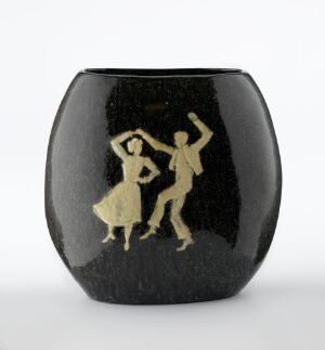  A black vase with a depiction of two dancers in a contrasting light color, possibly gold, illustrating a lively dance move with flared skirts and energetic postures.