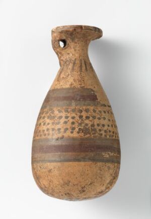  An ancient terracotta flask with a single handle, featuring horizontal bands of deep brown and lighter sandy colors with small dot patterns, indicating age and wear.