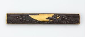  A narrow, decorative bar with intricate carvings, showcasing a dark, possibly black or deep brown base with lighter, possibly gold tone, details etched into it, set against a plain background.