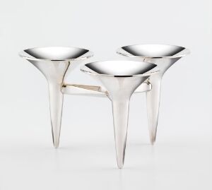  Two modern silver candleholders with an inverted cone design and reflective surface on a white background.