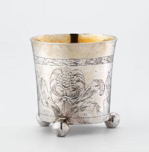  A silver goblet titled "Beger" designed by Niels Jacobsen Meier, featuring intricate engravings of a grapevine with a gilded interior, set against a neutral light gray background.