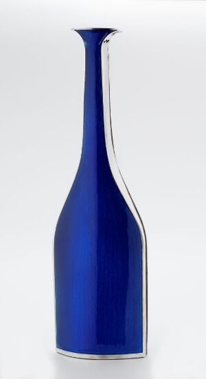  A sleek, cobalt blue vase with a gradient effect lightening towards the top, featuring an asymmetric modern design with a flat base and a flared opening.